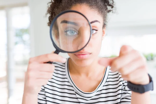 Young African American Woman Looking Magnifying Glass Pointing Finger Camera — Stock Photo, Image