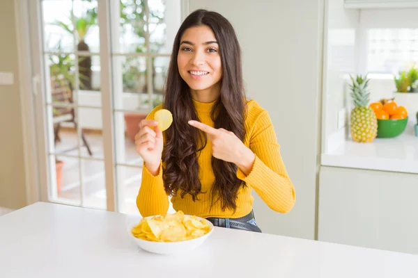 ファーストフードポテトチップスを食べる若い女性は 手と指で指差し非常に幸せ — ストック写真