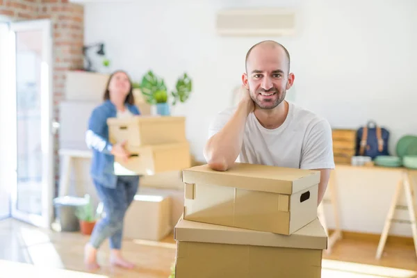 Young couple moving to new apartment, handsome man leaning on ca