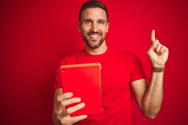 Young Man Using Digital Touchpad Tablet Red Isolated Background Very — Stock Photo, Image