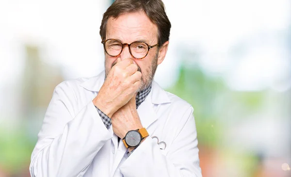 Middle Age Doctor Men Wearing Medical Coat Smelling Something Stinky — Stock Photo, Image