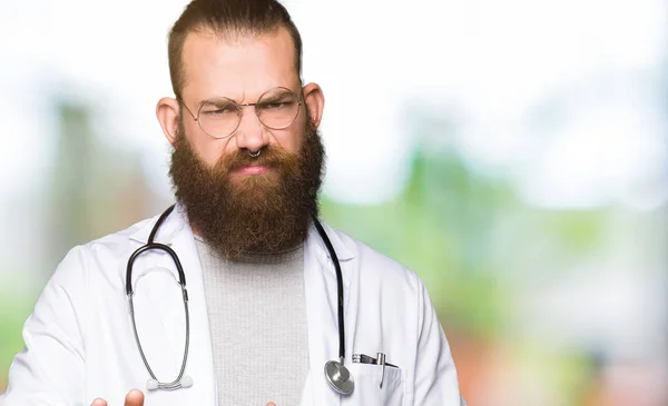 Jovem Médico Loiro Com Barba Vestindo Casaco Médico Expressão Repugnante — Fotografia de Stock