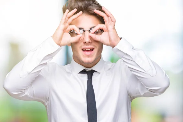 고립된 배경위에 안경을 사업가가 내밀고 손가락을 들여다보는 쌍안경같은 괜찮은 제스처를 — 스톡 사진