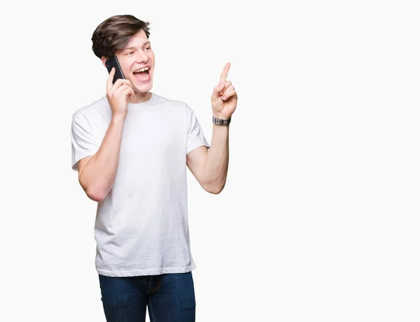 Young Man Talking Smartphone Isolated Background Very Happy Pointing Hand — Stock Photo, Image