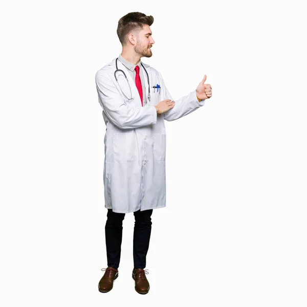 Young Handsome Doctor Man Wearing Medical Coat Looking Proud Smiling — Stock Photo, Image