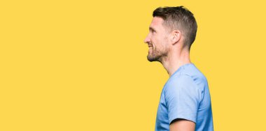 Yakışıklı Doktor adam izole arka tarafına, seyir üzerinde tıbbi üniforma dinlenmek doğal yüz emin gülümseme ile pozuyla profil.