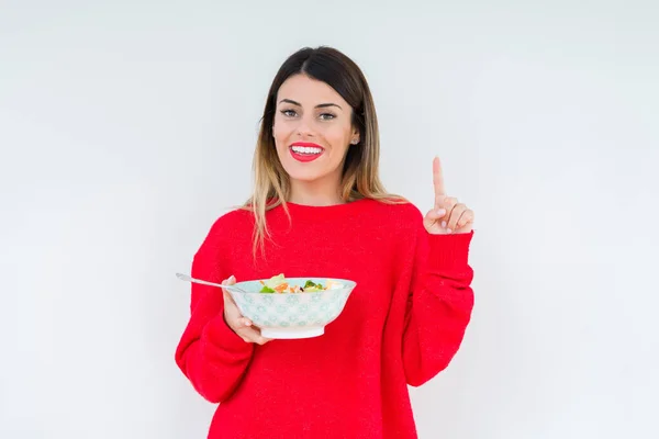 Jovem Mulher Comer Fresco Saudável Salada Sobre Isolado Fundo Surpreendido — Fotografia de Stock