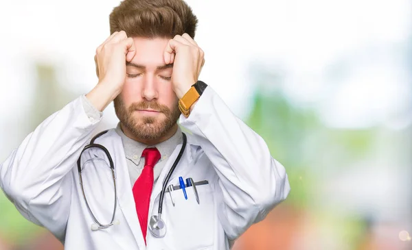 Young Handsome Doctor Man Wearing Medical Coat Suffering Headache Desperate — Stock Photo, Image