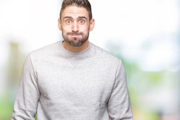 Joven Hombre Guapo Con Sudadera Sobre Fondo Aislado Hinchando Mejillas —  Fotos de Stock