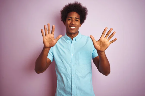青いシャツを着たアフロヘアの若いアメリカ人男性が 自信を持って幸せに微笑みながら 10番の指を見せ 指で指を上げている — ストック写真