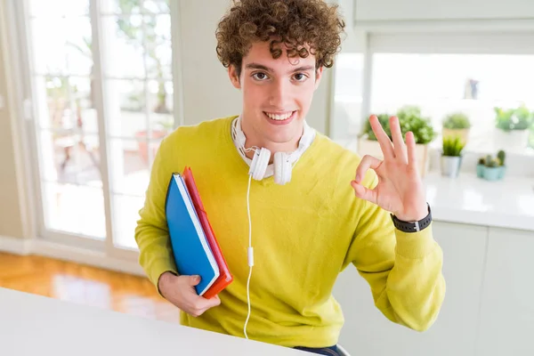 Joven Estudiante Usando Auriculares Portando Cuadernos Haciendo Signo Con Los — Foto de Stock