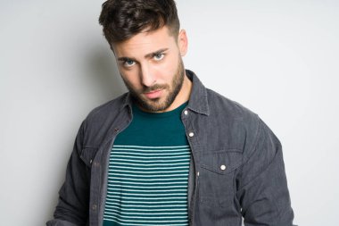 Yakışıklı delikanlı possing ve modelleme gri izole arka plan üzerinde