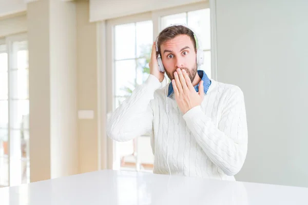 Handsome Man Wearing Headphones Listening Music Cover Mouth Hand Shocked — Stock Photo, Image