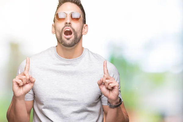 Junger Gutaussehender Mann Mit Sonnenbrille Vor Isoliertem Hintergrund Staunend Und — Stockfoto