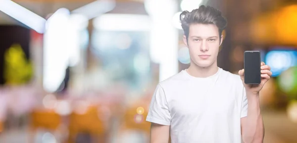 Young Man Showing Smartphone Screen Isolated Background Confident Expression Smart — Stock Photo, Image