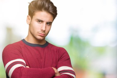 Yakışıklı delikanlı izole arka plan şüpheci ve sinir, onaylamayan ifade yüz çapraz kolları üzerinde. Negatif kişi.