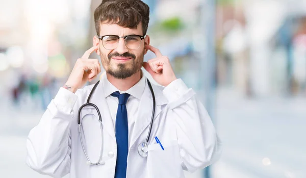 Young Doctor Man Wearing Hospital Coat Isolated Background Covering Ears — Stock Photo, Image