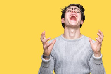 Üzerinde gözlük takan genç yakışıklı adam arka plan deli izole ve deli bağırarak ve agresif ifade ve silah kaldırdı bağırıyor. Hayal kırıklığı kavramı.