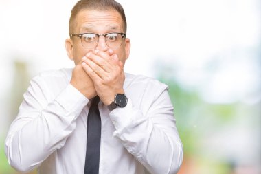 Orta yaş bussines Arap adam gözlüklü üzerinde arka plan ağız hata için elleriyle kapsayan şok izole. Gizli kavramı.