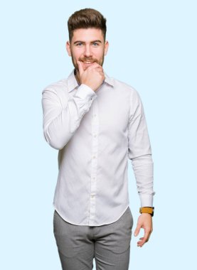 Genç yakışıklı iş adamı emin çapraz kollar ve çeneme kaldırdı el ile gülümseme ile kameraya bakıyor. Pozitif düşünce.