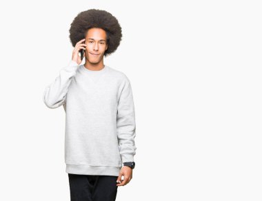 Acımak yüz ciddi düşünüyorum üstünde kendine güvenen bir ifade ile smartphone üzerinde konuşurken afro saçlı genç Afro-Amerikan adam