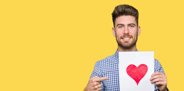 Young Handsome Man Holding Paper Red Heart Very Happy Pointing — Stock Photo, Image