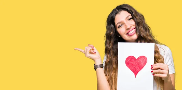 Young Adult Woman Holding Card Red Heart Very Happy Pointing — Stock Photo, Image