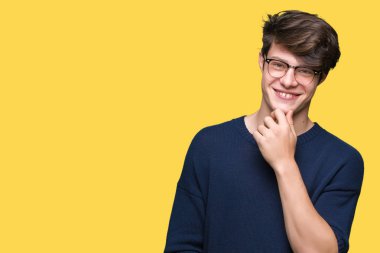 Çene düşünme hakkında soru, dalgın ifade üzerine el ile izole arka plan üzerinde gözlük takan yakışıklı delikanlı. Düşünceli yüzüyle gülümsüyor. Şüphe kavramı.