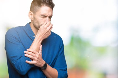 Yakışıklı delikanlı bir şey pis ve iğrenç kokulu izole arka plan, dayanılmaz koku, holding nefes burun parmaklar ile. Kötü kokuyor kavramı.