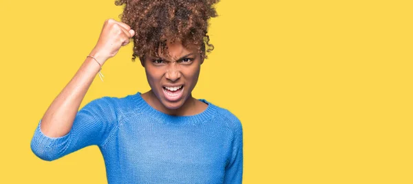 stock image Beautiful young african american woman over isolated background angry and mad raising fist frustrated and furious while shouting with anger. Rage and aggressive concept.