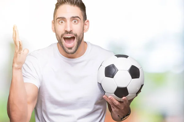 Молодой Человек Держащий Футбольный Мяч Изолированном Фоне Счастливый Взволнованный Победитель — стоковое фото