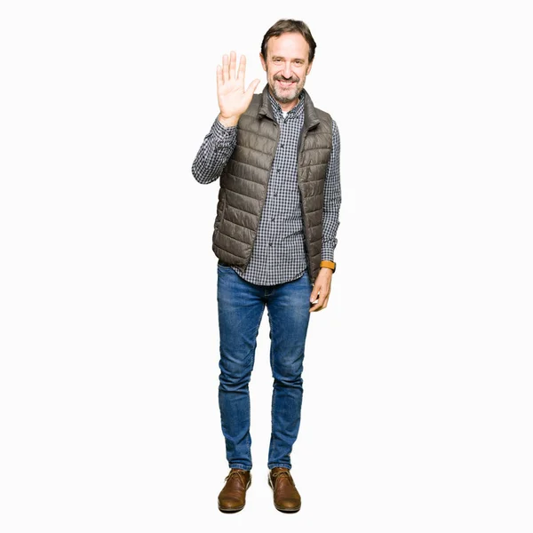 Middle Age Handsome Man Wearing Winter Vest Waiving Saying Hello — Stock Photo, Image