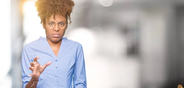 Beautiful young african american business woman over isolated background disgusted expression, displeased and fearful doing disgust face because aversion reaction. With hands raised. Annoying concept.