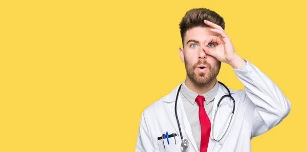 Young Handsome Doctor Man Wearing Medical Coat Doing Gesture Shocked — Stock Photo, Image