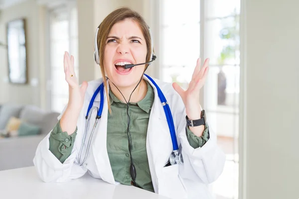 Beautiful Young Doctor Woman Wearing Headset Crazy Mad Shouting Yelling — Stock Photo, Image