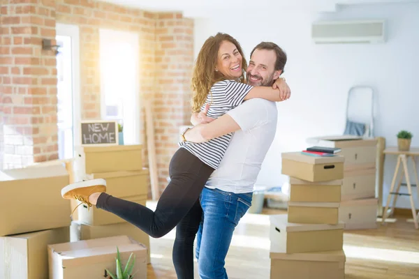 Seniorenpaar mittleren Alters zieht in ein neues Haus, lächelt glücklich in — Stockfoto