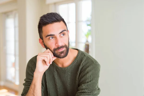 Handsome man thinking confused about doubt, questioning an idea