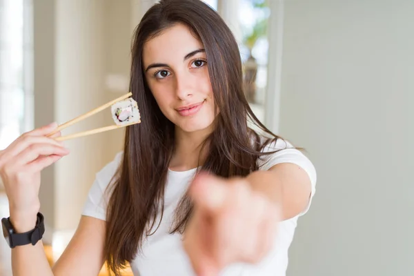 Beautiful Young Woman Eating Asian Sushi Using Chopsticks Pointing Finger — Stock Photo, Image