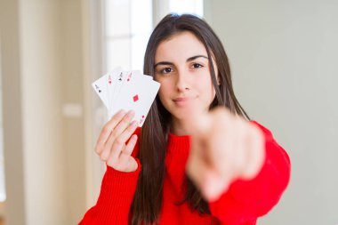 Kameraya parmak ile işaret poker oynarken güzel genç kadın kumar ve ön, el işareti, olumlu ve emin jest