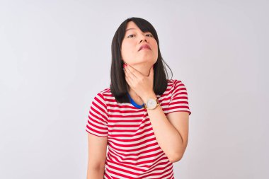 Genç güzel Çinli kadın izole beyaz arka plan üzerinde kırmızı çizgili t-shirt giyiyor ağrılı boyun, grip, kesek ve enfeksiyon için boğaz ağrısı dokunmadan
