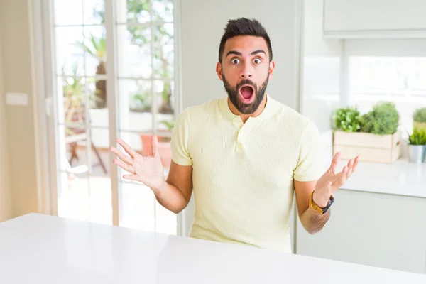 Handsome Hispanic Man Casual Yellow Shirt Home Celebrating Crazy Amazed — Stock Photo, Image