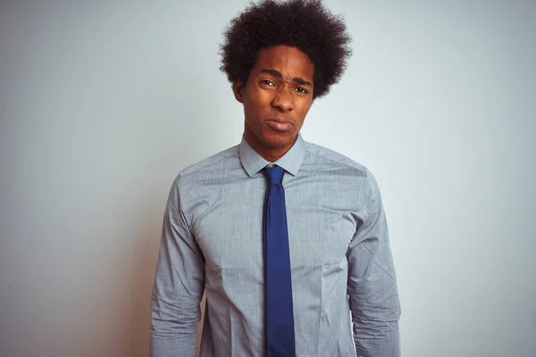 American business man with afro hair wearing shirt and tie over isolated white background depressed and worry for distress, crying angry and afraid. Sad expression.