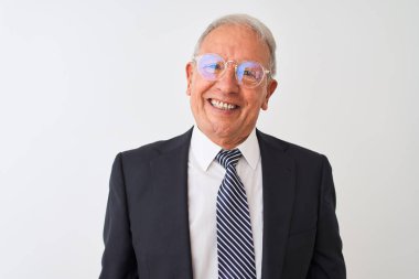 Üst düzey gri saçlı işadamı yüzünde mutlu ve serin bir gülümseme ile izole beyaz arka plan üzerinde takım elbise ve gözlük giyiyor. Şanslı kişi.