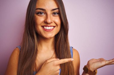 Genç güzel kadın el ve parmak ile işaret çok mutlu izole pembe arka plan üzerinde ayakta t-shirt giyiyor