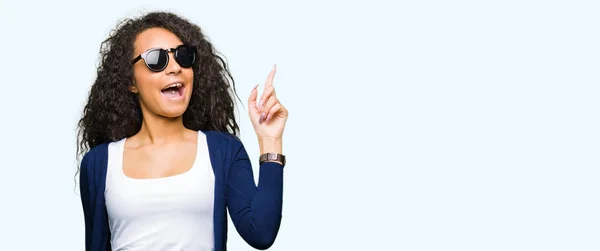 Young Beautiful Girl Curly Hair Wearing Fashion Sunglasses Pointing Finger — Stock Photo, Image