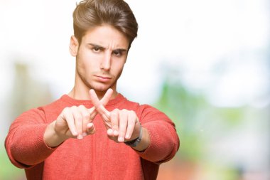 Eksi işareti yapıyor izole arka plan ret ifade geçiş parmakları genç yakışıklı adam