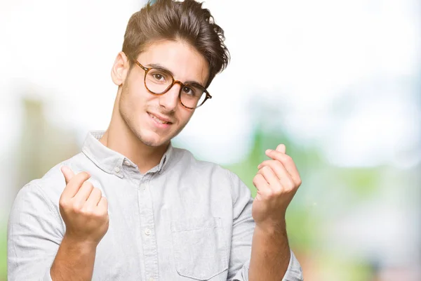 Junger Gutaussehender Mann Mit Brille Über Isoliertem Hintergrund Macht Geldgeste — Stockfoto