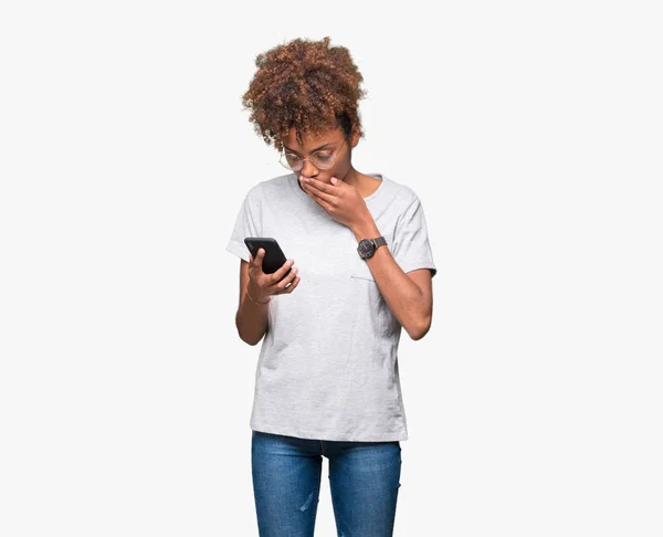 Young African American Woman Using Smartphone Isolated Background Cover Mouth — Stock Photo, Image