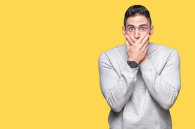 Üzerine tişört giyen genç yakışıklı adam arka plan ağız hata için elleriyle kapsayan şok izole. Gizli kavramı.