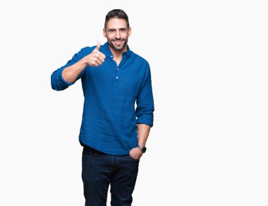 Yakışıklı delikanlı hareketi el ile mutlu yaşasın yapıyor izole arka plan üzerinde. Başarı gösteren kameraya bakarak ifade onaylama.